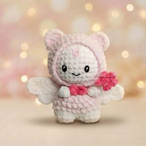 Muñeco amigurumi Stay with Your Wings tejido a crochet, diseño fan-made inspirado en Stray Kids, en tonos rosa y blanco
